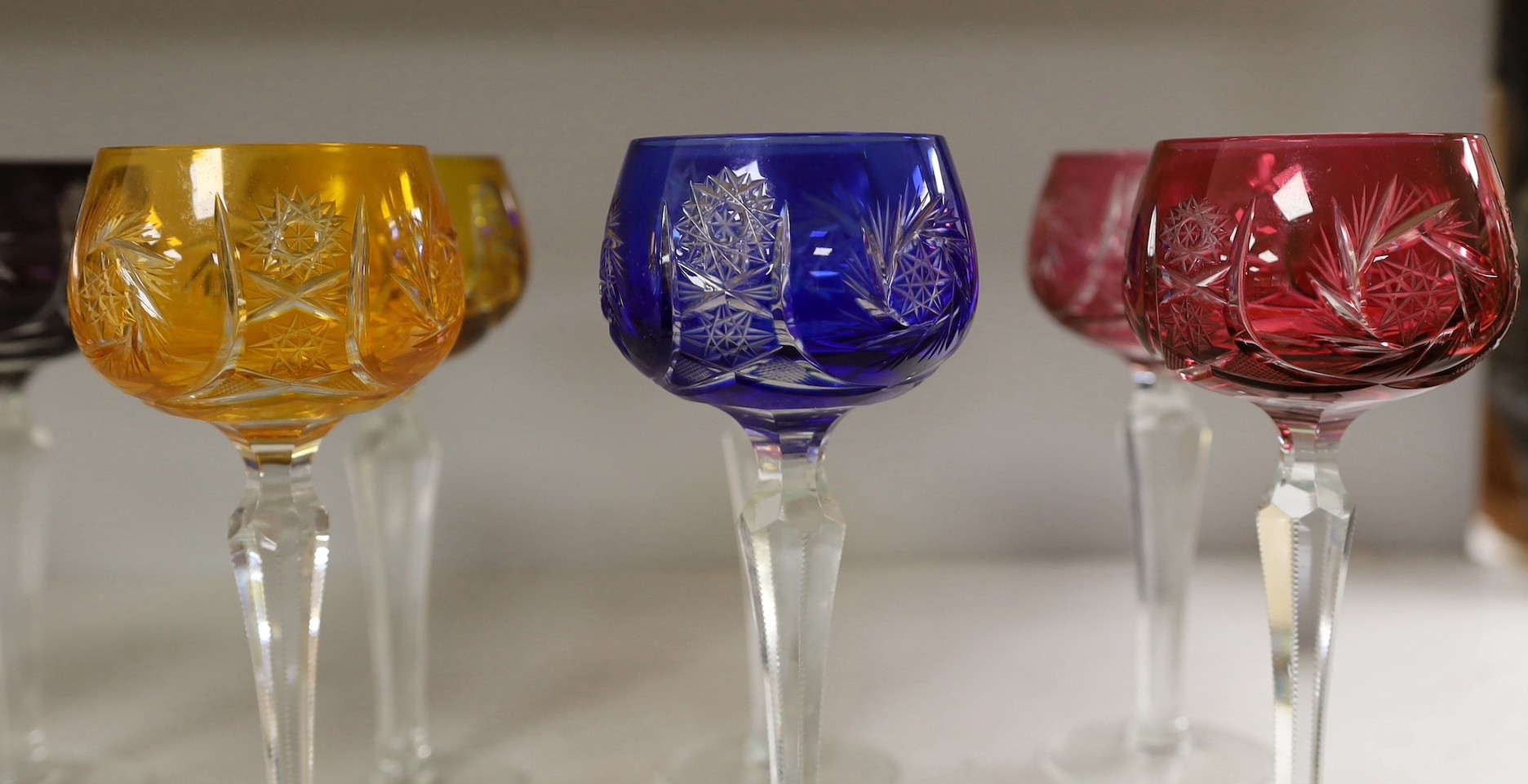 A set of eleven cut and coloured hock glasses